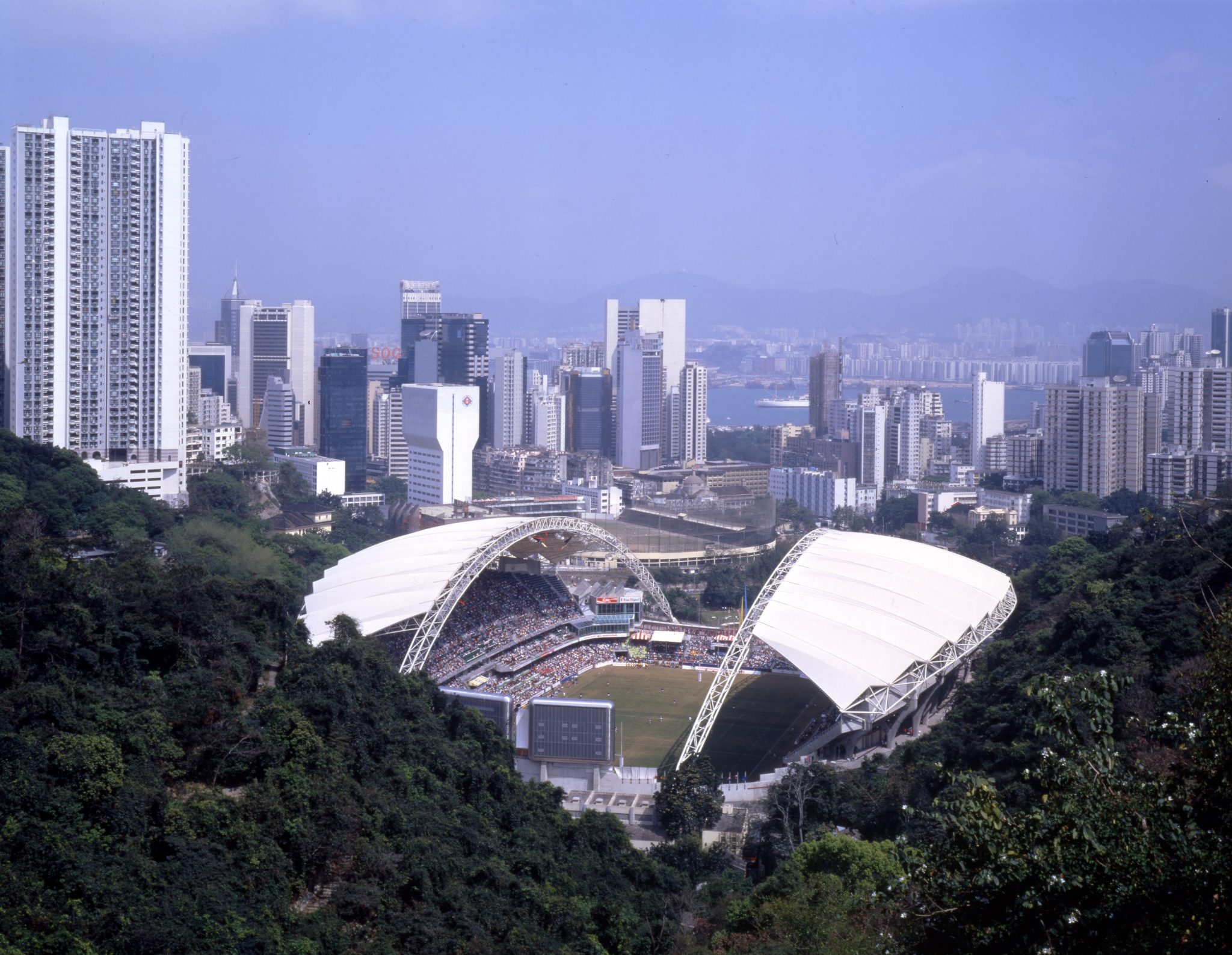 Hong Kong Stadium is nestled in a valley of a tropical forest where the topography soars 300 feet above the surface of the pitch