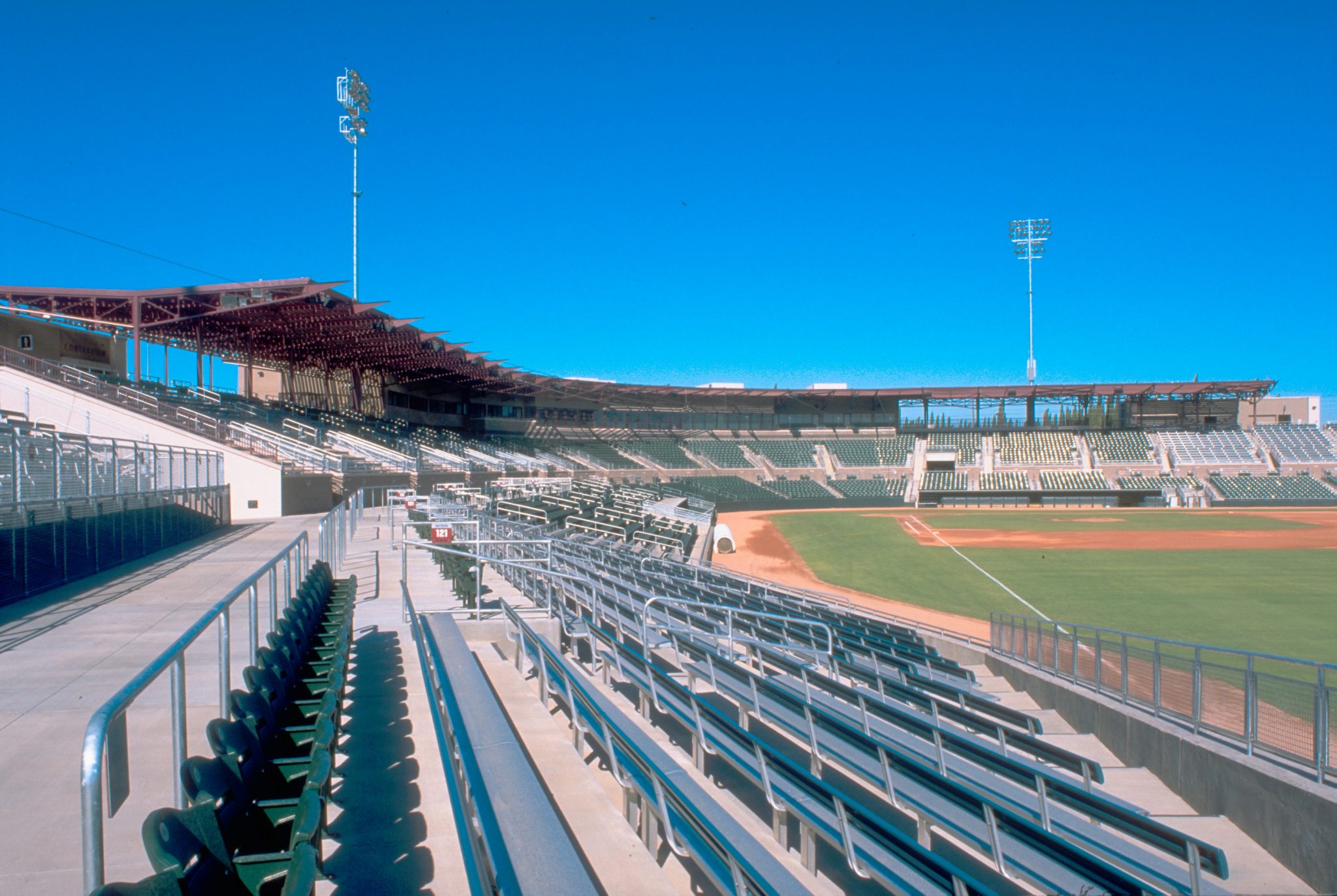 A steel canopy above upper deck captures baseball's early era feeling.
